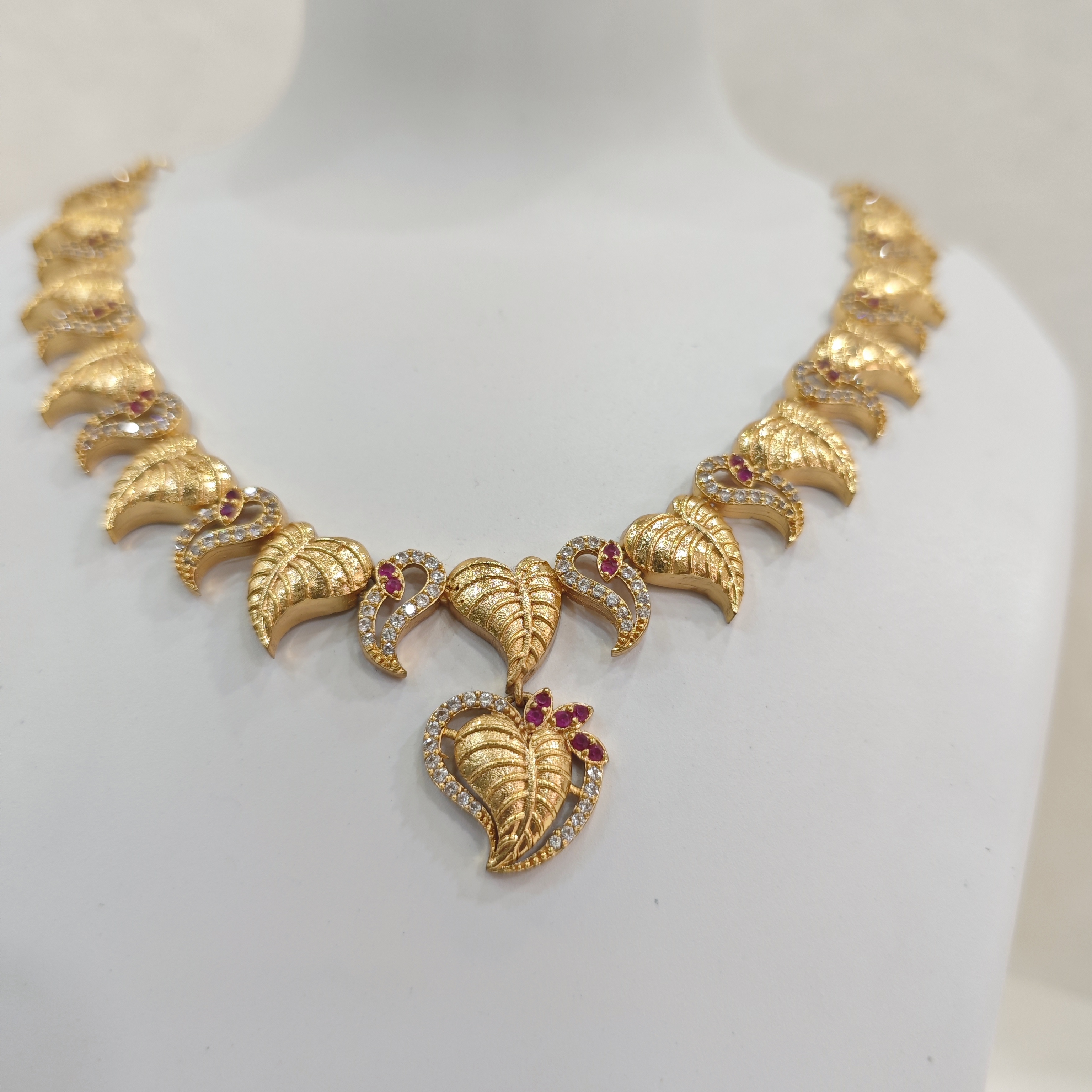 Gold-Plated Leaf Motif Necklace Set with Ruby and White Stones