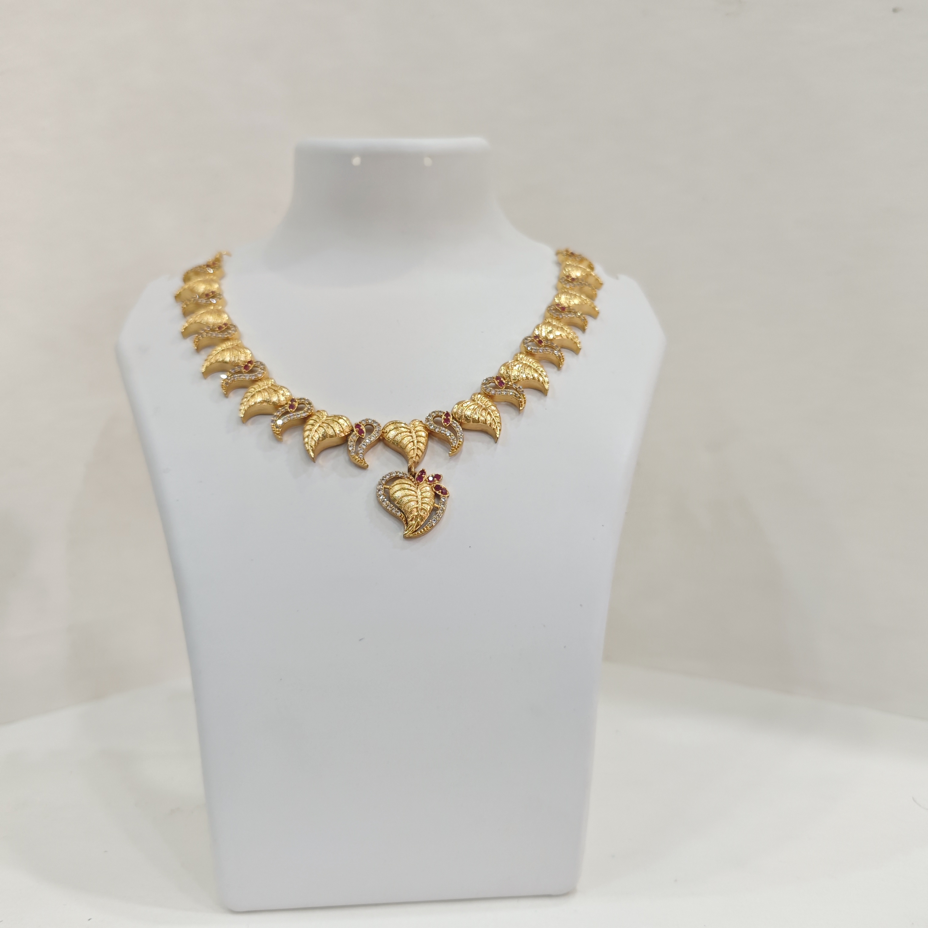 Gold-Plated Leaf Motif Necklace Set with Ruby and White Stones