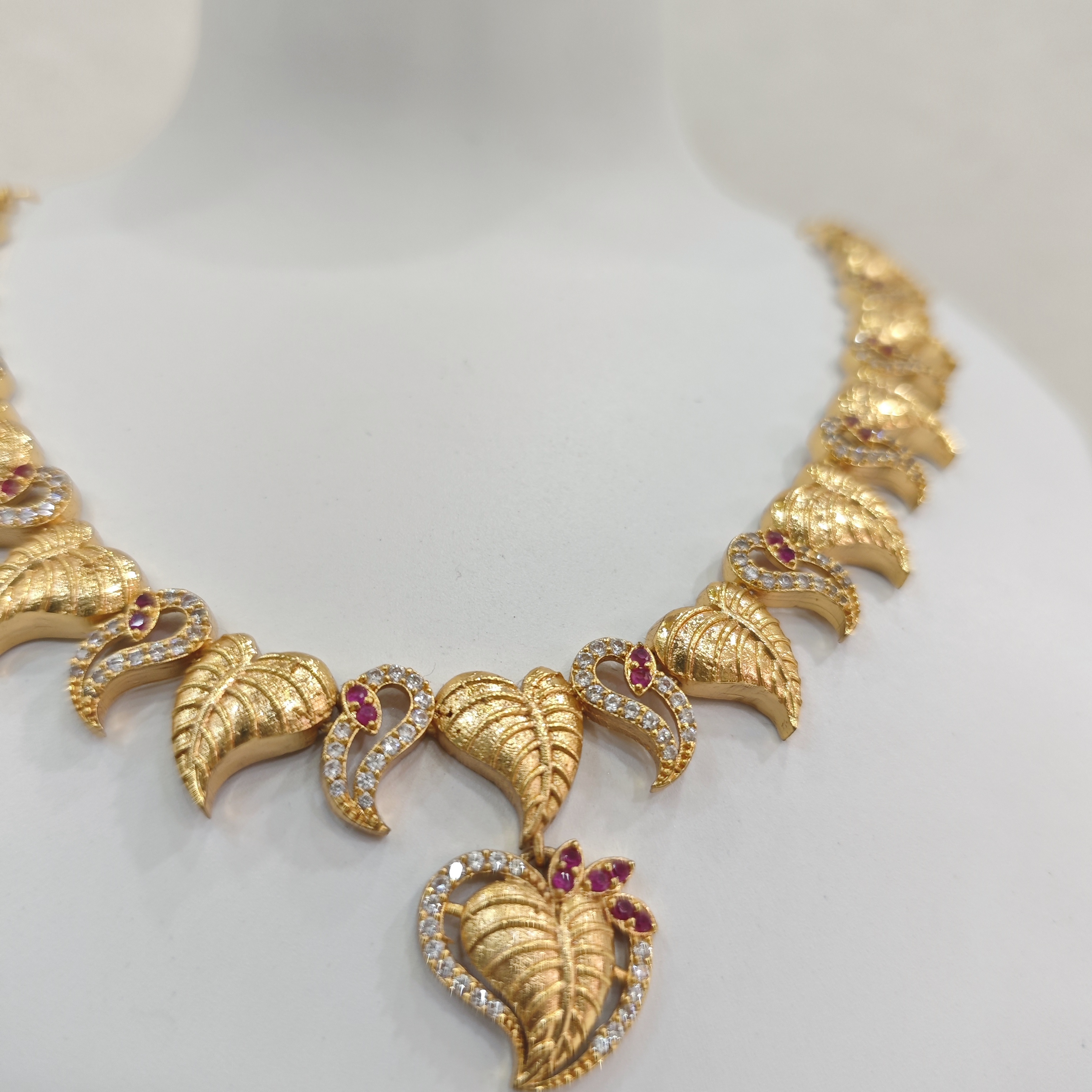 Gold-Plated Leaf Motif Necklace Set with Ruby and White Stones