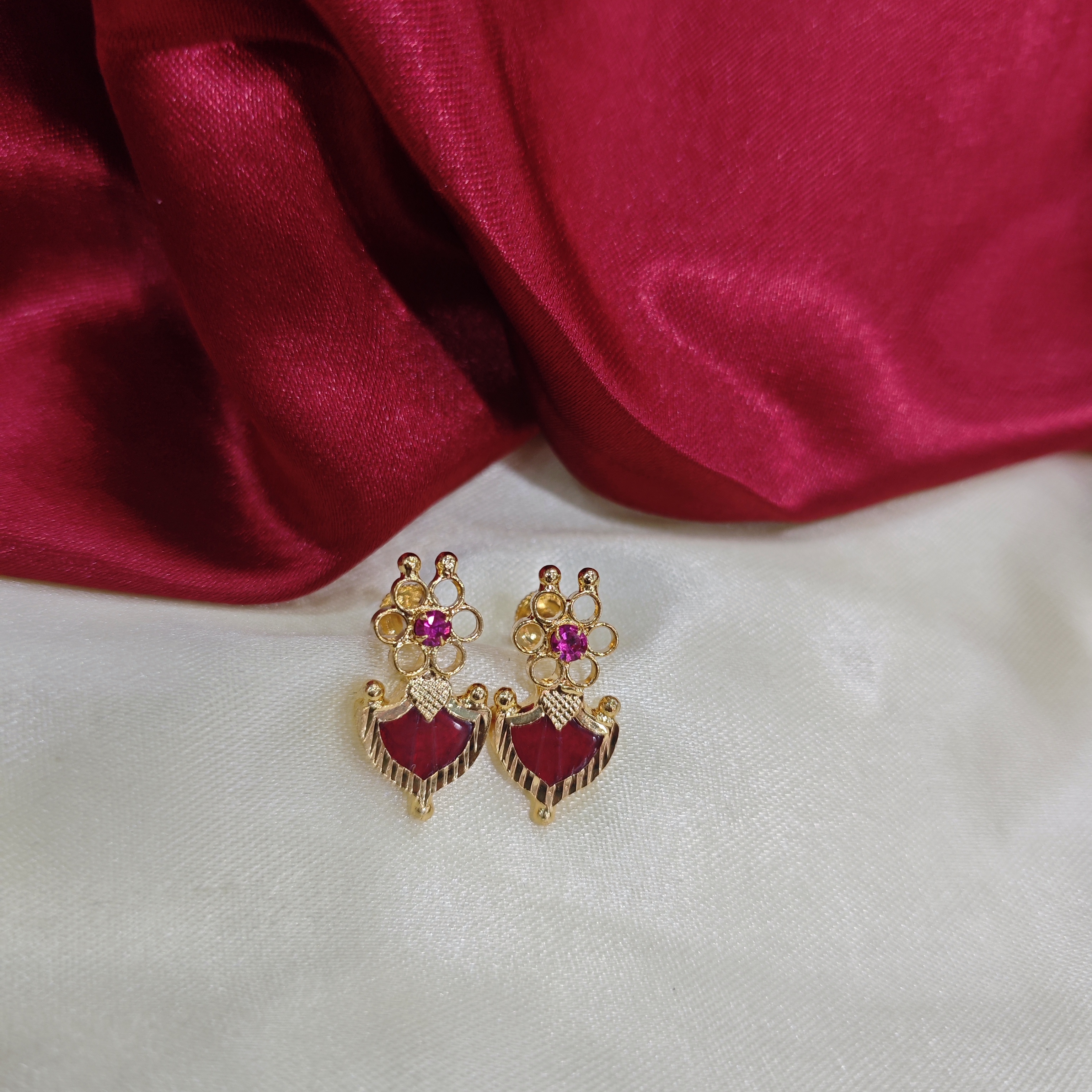 Gold plated flower red palakka stud with ruby stone